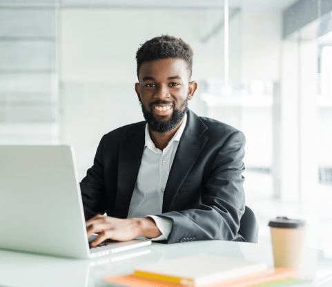 image of a smiling young african-american man working on a compuer